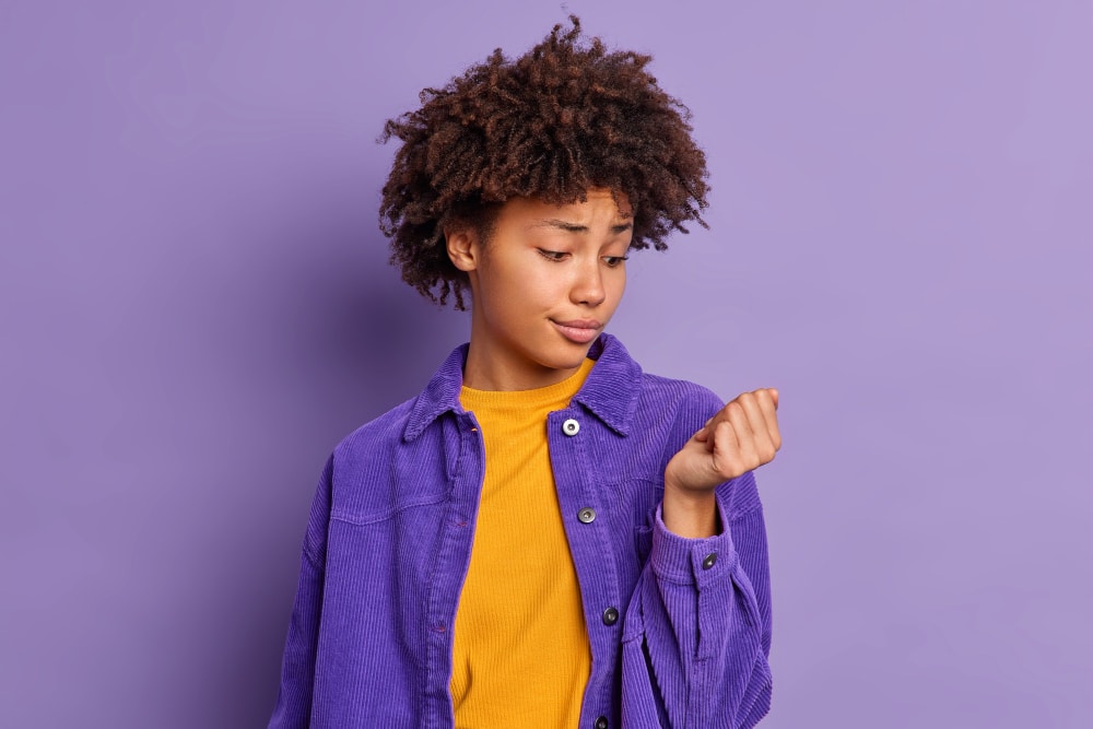 electric nail file damage: Image of a girl looking at her nails